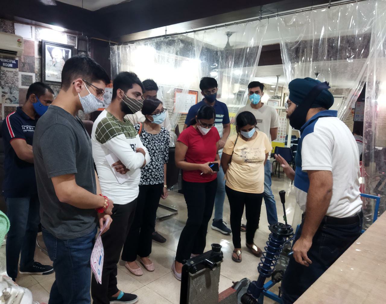 Our Expert Showing Car Engine to Student at PRM Car Driving School